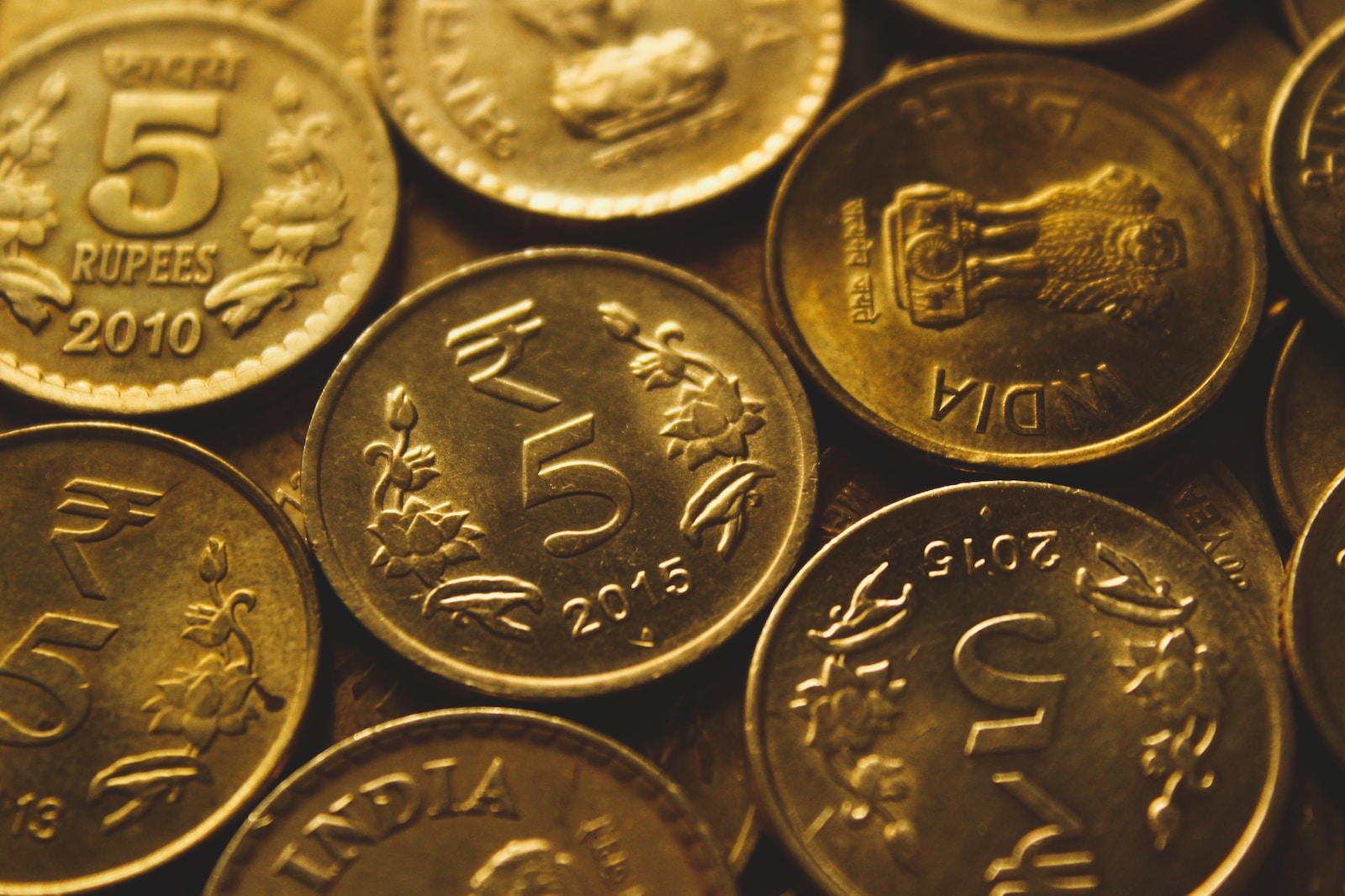 round gold-colored coin lot close-up photography