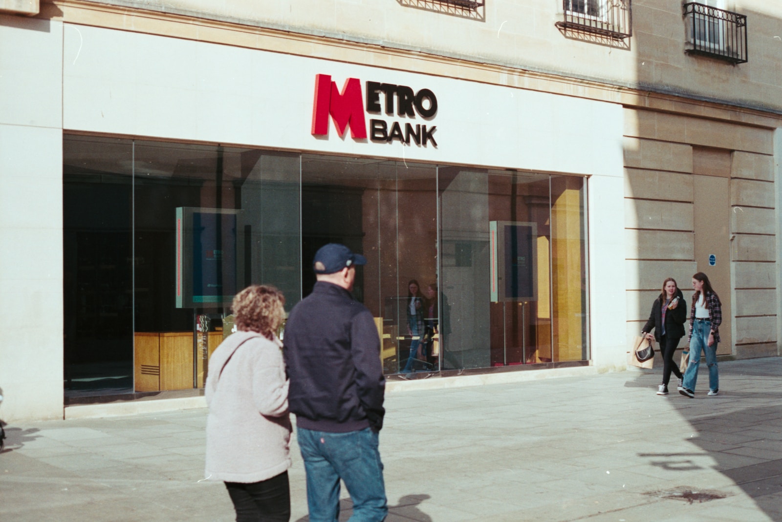 people walking in front of a store