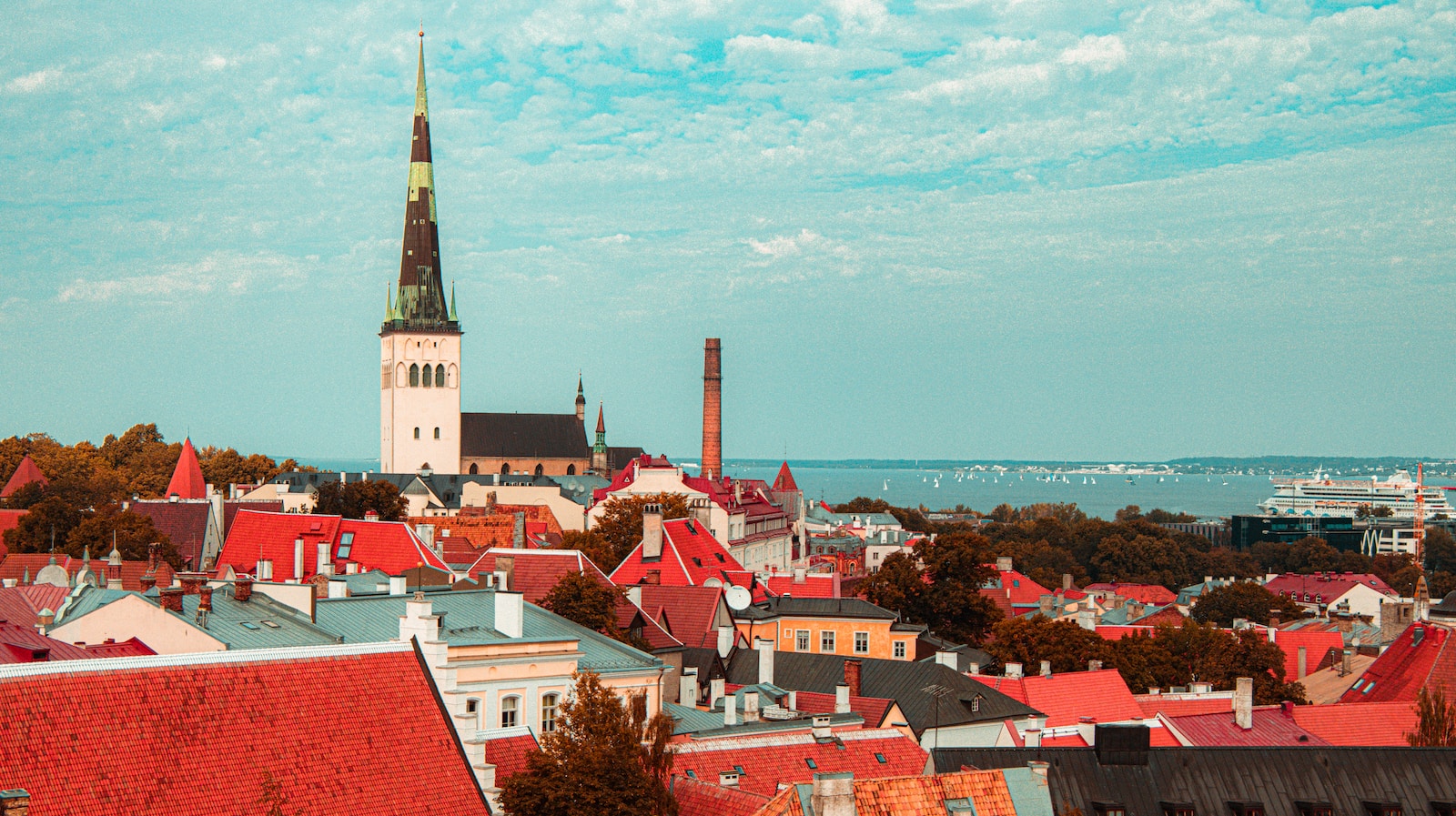 Photo by Alexander Kovalev a view of a city with a steeple in the background
