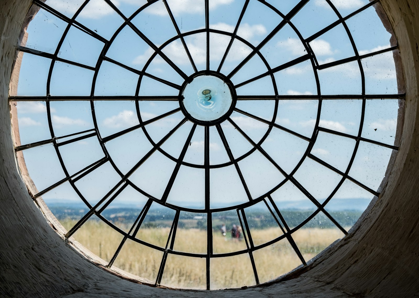 brown wooden round table with blue and white glass roof