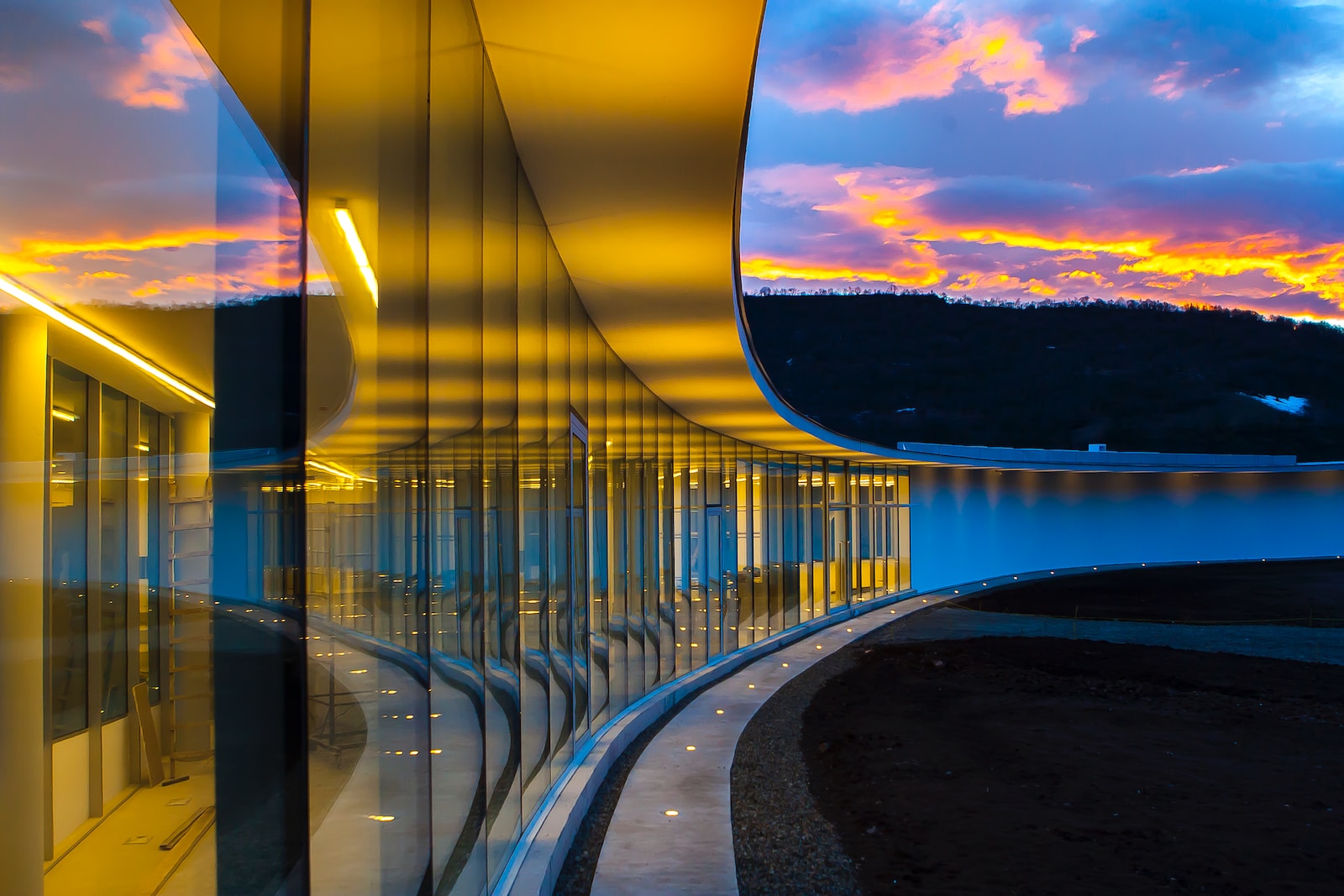 clear glass wall building under blue sky with clouds