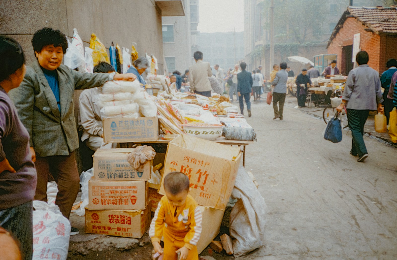 Photo by Annie Spratt A group of people walking down a street next to a pile of boxes